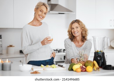 We love starting our days together. Shot of two friends having juice and smoothies together. - Powered by Shutterstock