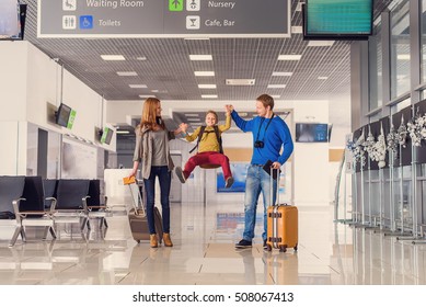 We Love Traveling. Happy Family With Kid In Airport Having Fun While Waiting For Boarding