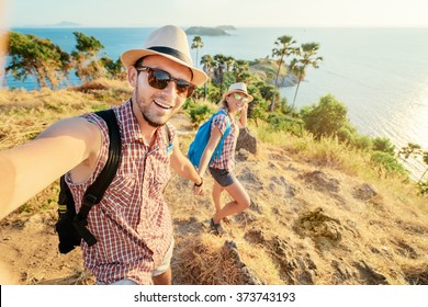 We love traveling and trekking! Adventure Selfie. Caucasian young loving couple taking selfie while they walking on mountains near the sea. - Powered by Shutterstock