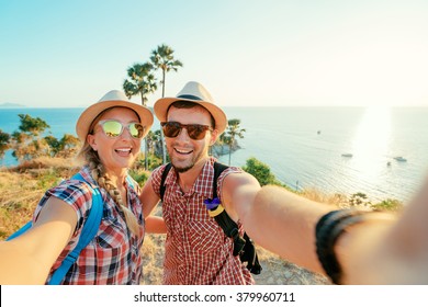 We love traveling and trekking! Adventure Selfie. Caucasian young loving couple taking selfie while they walking on mountains near the sea. - Powered by Shutterstock