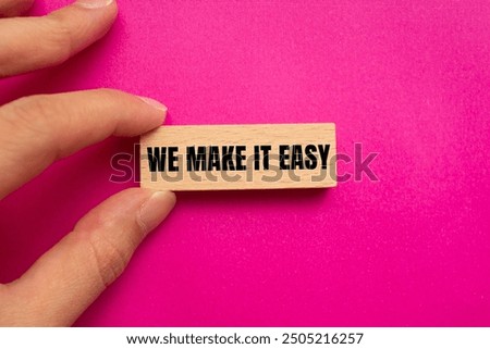We make it easy message written on wooden block with pink background. Conceptual we make it easy symbol. Copy space.