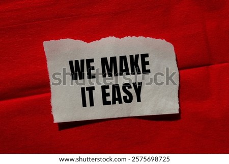 We make it easy message written on ripped torn paper piece on red background. Conceptual we make it easy symbol. Copy space.