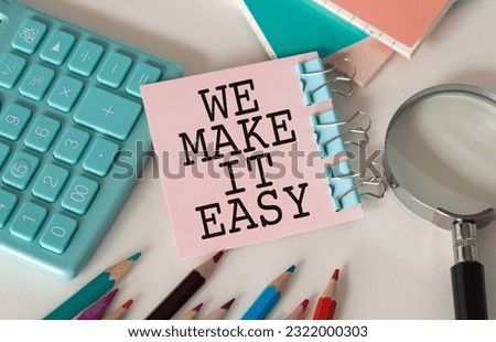 We Make it Easy, text on notepad on white background near keyboard and glasses