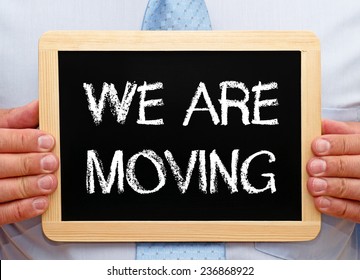 We are moving - Businessman with chalkboard