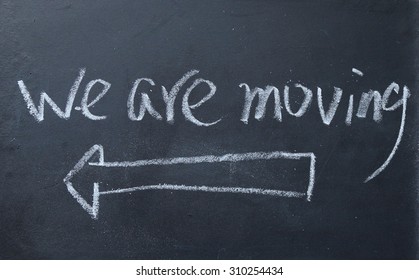 We Are Moving Sign On Blackboard