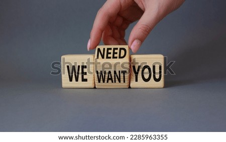 We need and want You symbol. Businessman Hand turns cubes and changes word We want you to We need you. Beautiful grey background. Business and We need and want You concept. Copy space