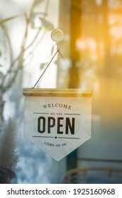 We Are Open Sign And Chain Hangs On A Glass Storefront Or Door Due To The Shop Or Retail Business , Welcome Come On In.