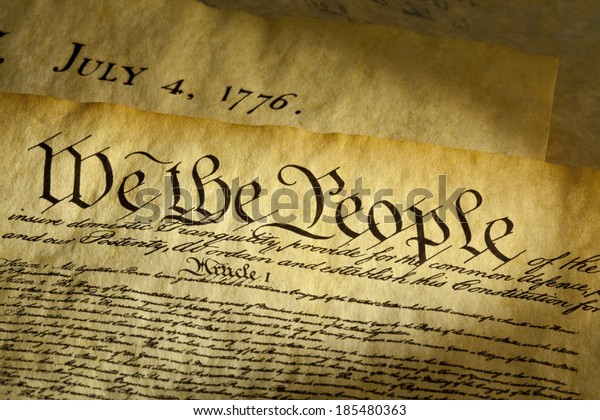 We the People are the opening words of the preamble to\
the Constitution of the USA. The document underneath is a copy of\
the Declaration of Independence with the date, July 4, 1776\
showing.  
