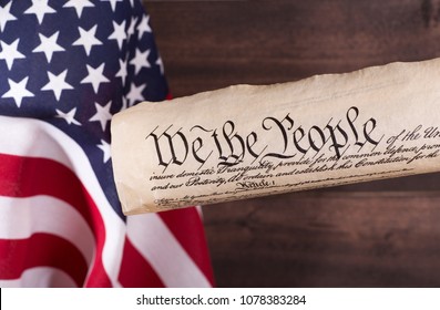 We The People, Preamble To The United States Constitution, With The American Flag In Background