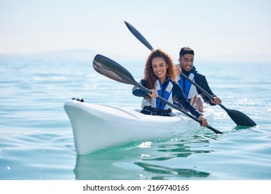We row together, we grow together. Portrait of a young couple kayaking together at a lake.