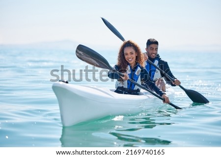 We row together, we grow together. Portrait of a young couple kayaking together at a lake.