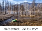 
We see a beautiful landscape next to a forgotten canoe, a lot of still life and in the background mountains and blue sky, next to calm waters of the lake, Potrerillos Mendoza Arg.