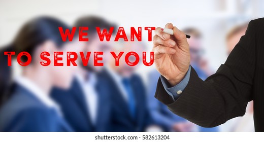 We Want to Serve You, Male hand in business wear holding a thick pen, writing on an imaginary screen at the camera, business team in background, digital composing.