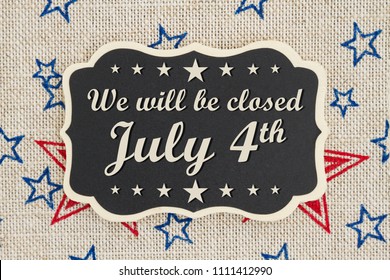 We Will Be Closed July 4th Text For Independence Day On A Chalkboard With Patriotic USA Red And Blue Stars On Burlap