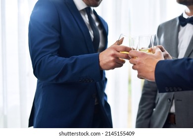 We wish you a lifetime of love and happiness buddy. Shot of two unrecognizable groomsmen sharing a toast with the bridegroom on his wedding day.