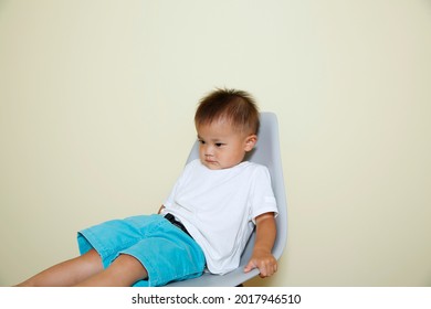 Weak Boy Sitting In A Chair