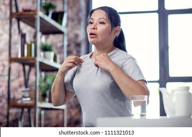 Weak Immune System. Ill Dreary Woman Posing On Blurred Background And Coping With Flu