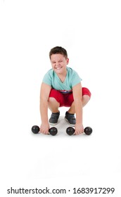 A Weak Plump Teenage Boy Feels Pain With Powerless Expression And Struggle Lifting The Weights. Isolated On White Background