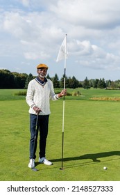 Wealthy African American Senior Man Standing With Flag Stick And Golf Club