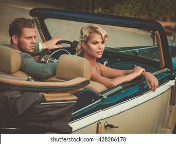 Wealthy Couple In A Classic Convertible 