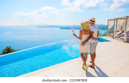 Wealthy couple enjoying beautiful sea view of luxury Mediterranean villa
