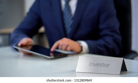 Wealthy Investor Using Tablet Pc, Studying Successful Investment Opportunities