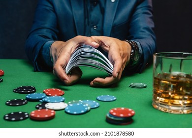 A Wealthy Man Drinking Brandy And Playing Poker With The Excitement In A Casino.