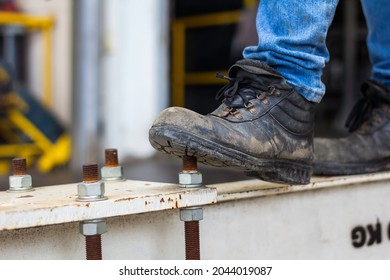 Wear safety shoes to ensure safety at work. construction workers wear safety shoes. People with factory safety concept - Shutterstock ID 2044019087