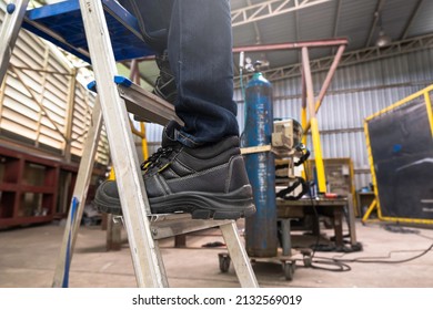 Wear safety shoes to ensure safety at work. construction workers wear safety shoes. concept. Construction workers work on the stairs - Shutterstock ID 2132569019
