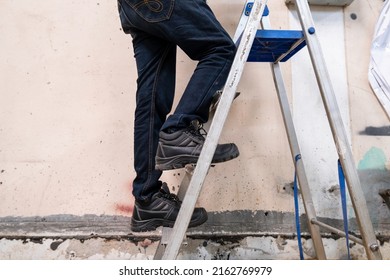 Wear safety shoes to ensure safety at work. construction workers wear safety shoes. concept. Construction workers work on the stairs - Shutterstock ID 2162769979