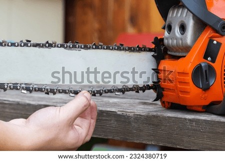 wear and tear of the chain on the chainsaw bar. Chain adjustment and tension.