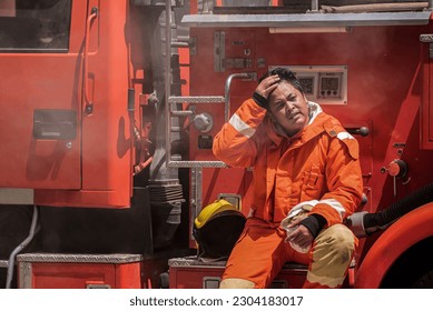 With a wearied expression and soot stained gear the firefighter reflects on the intense firefighting efforts and the lives impacted by the fire. - Powered by Shutterstock