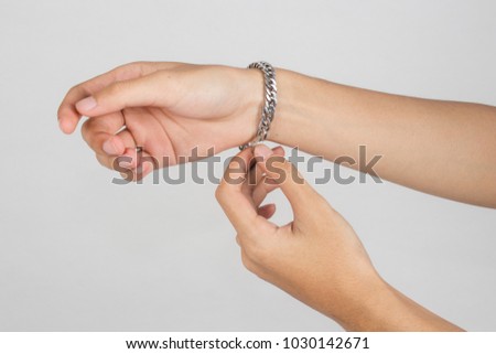 Wearing a bracelet on arm isolated on white background.