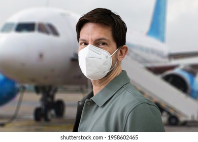 Wearing FFP2 Facemask In Airport. Plane Travel In Mask