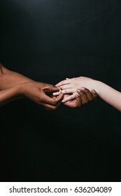 Wearing Marriage Ring, Proposal, Interracial Relationship. Black And White Hands, Closeup On Dark Background With Free Space.