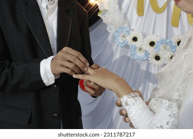 Wearing a ring at a wedding ceremony - Shutterstock ID 2311787217