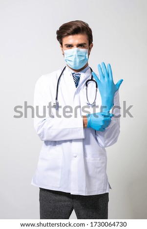 wearing steril gloves is the best way to avoid virus or bacteria contact for doctors, young medic fixing his latex blue gloves