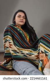 Wearing Traditionaly Beautiful Colorful Poncho A Young Latin Woman With Black Hair, Natural Beauty And Fashion Of Latin American Culture In Studio