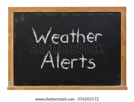 Weather alerts written in white chalk on a black chalkboard isolated on white