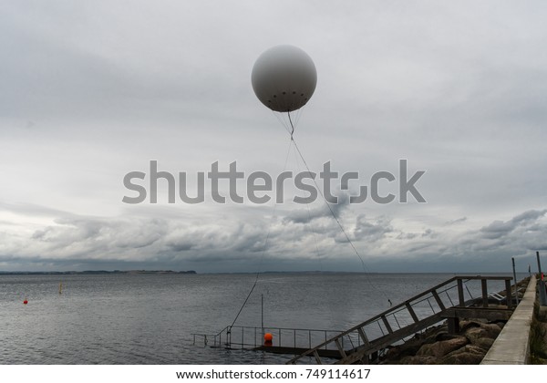 weather balloon flies on the sea near the haven
of Aarhus.