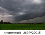 WEATHER - Dramatic black rain clouds over fields and country road. 20