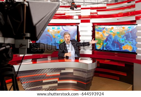 Weather forecast. A television anchorman at studio during live broadcasting