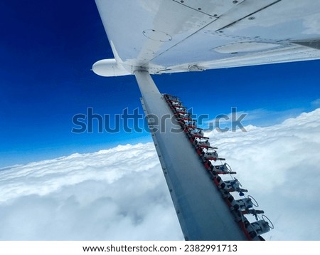 Weather modification technology uses airplanes that circle clouds in the blue sky