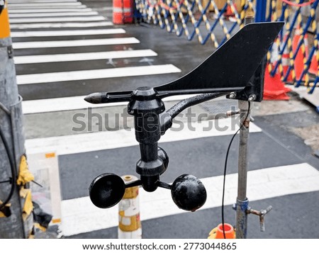 A weather sensor can simultaneously measure wind speed and direction. It consists of a rotating cup (anemometer) and a wind vane (wind direction indicator).