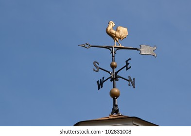 Weather vane  against a  blue sky