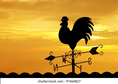 Weather Vane In Colorful Sky ,on The Roof