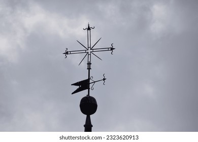 weather vane on top of the bell tower