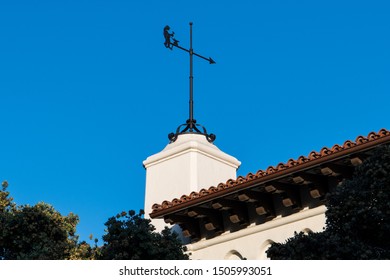 Weather Vane On Top Of A White Spanish Colonial Revival Architecture Style Building With A Red Tile Roof - Santa Barbara, California