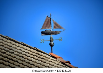 Weather Vane Sail Ship On A Roof With Blue Sky