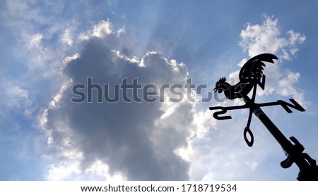Weathercock with Cloudy Blue Sky